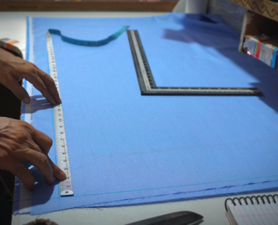 Premium stitched suits displayed in a tailoring studio
